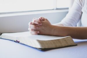 Prayer hands with Bible